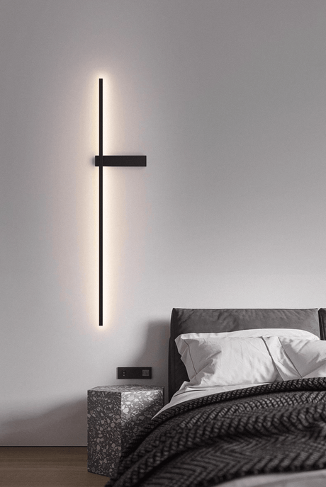 Lit beside a bed with a knitted throw, the crossbar mount at hand height