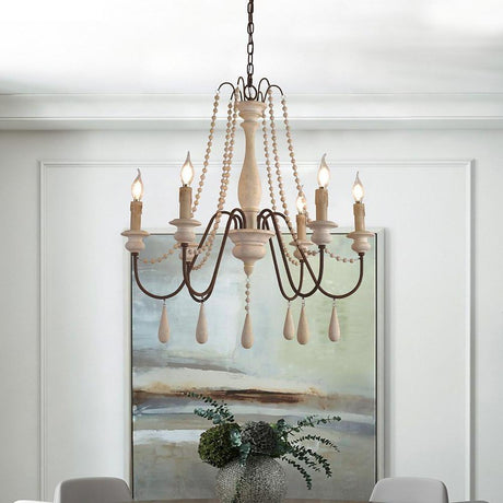 Lit in front of a large framed painting above a console with a plant