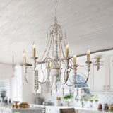 Lit under a white plank ceiling in a kitchen above a counter with plants