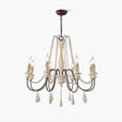 Wooden bead strands swagged across scrolling iron arms with candle lamps above