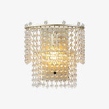 The beaded sconce lit warm on a white background
