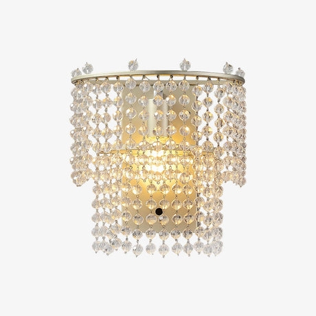 The beaded sconce lit warm on a white background
