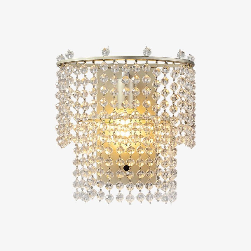 The beaded sconce lit warm on a white background