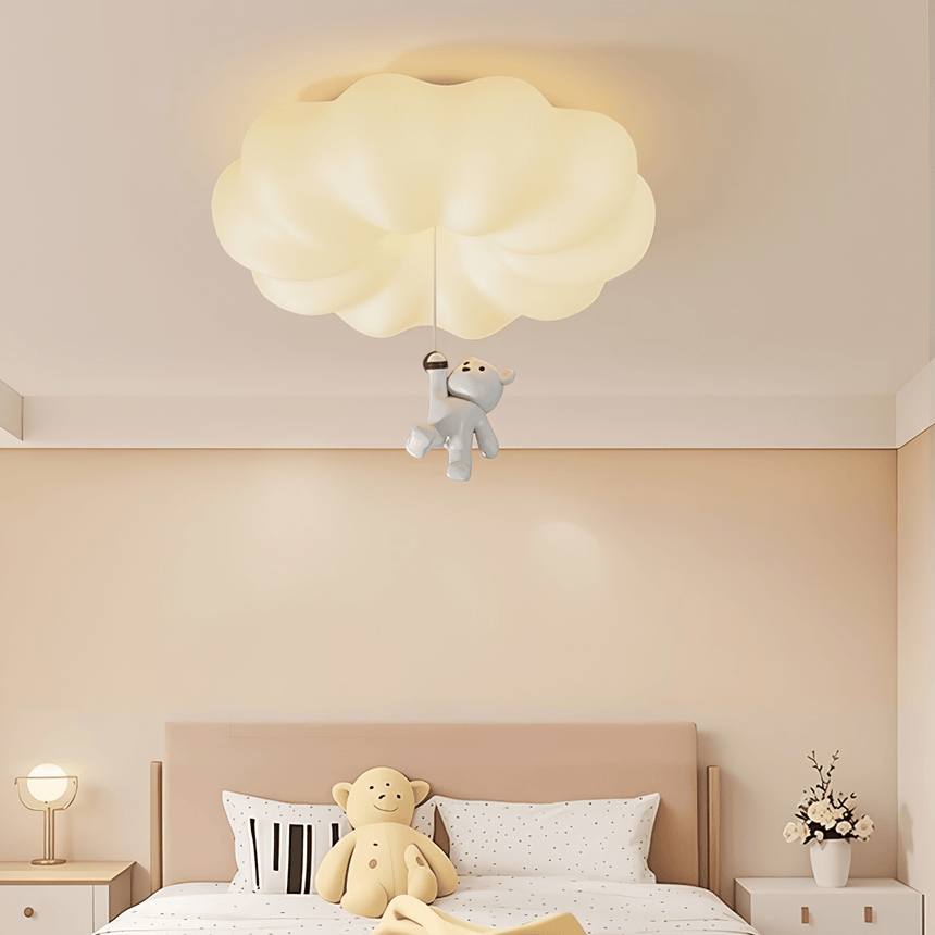 Cloud bear ceiling light above a bed with a teddy bear and two bedside lamps