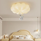 Cloud bear ceiling light in a child room with an arched headboard and a table lamp