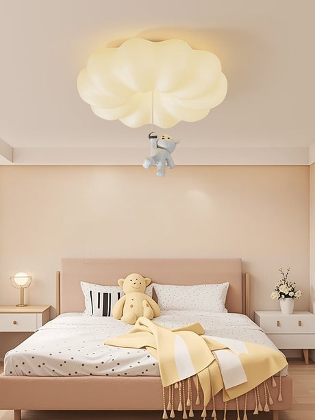 Cloud bear ceiling light in a child bedroom with a yellow throw and a pink bed
