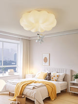 Bear ceiling light lit in a bright bedroom with a city view through the window