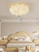 Bear ceiling light in a child room with a cloud headboard and a soft toy on the bed