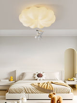 Cloud bear ceiling light above a low bed with a soft toy bear on the floor