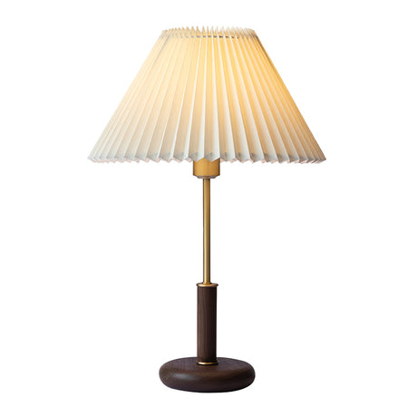 Pleated shade bedside lamp seen in full, shade, brass stem and walnut base