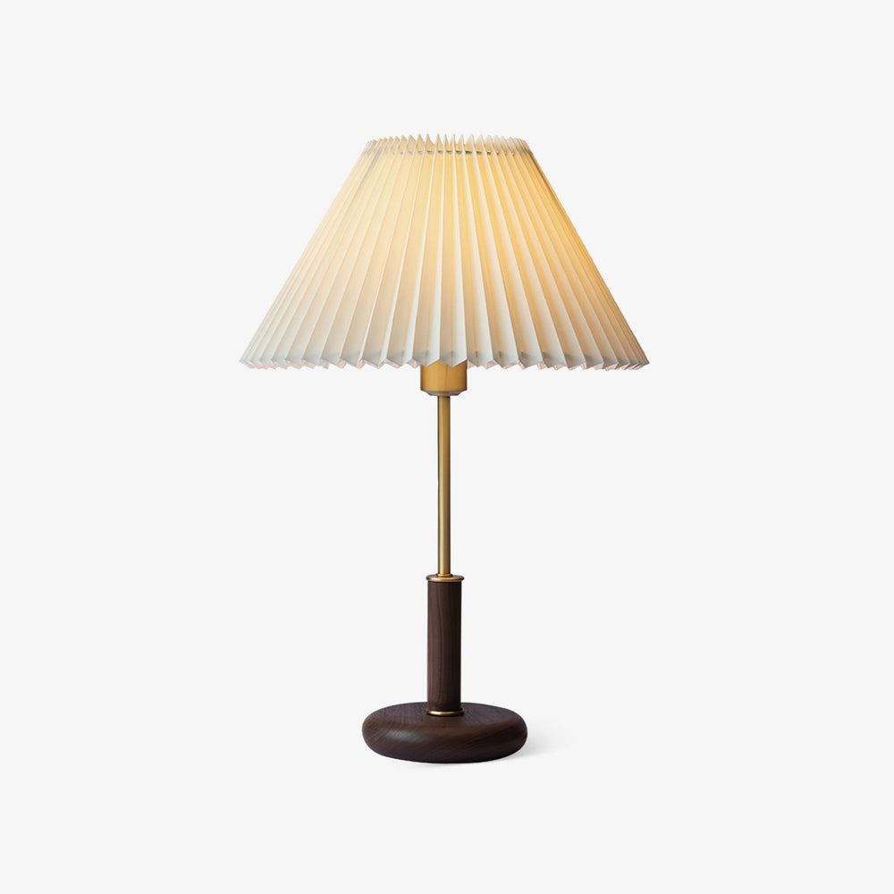 Bedside lamp with a white pleated shade on a walnut and brass stem, plain background