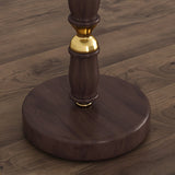 Close view of the round walnut disc base and the brass collar above it