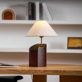 Bedroom table lamp on a desk with open shelving behind it