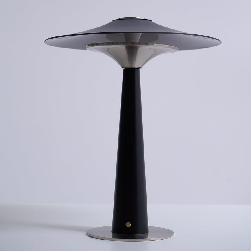 Bedroom table lamp seen from the front against a plain ground