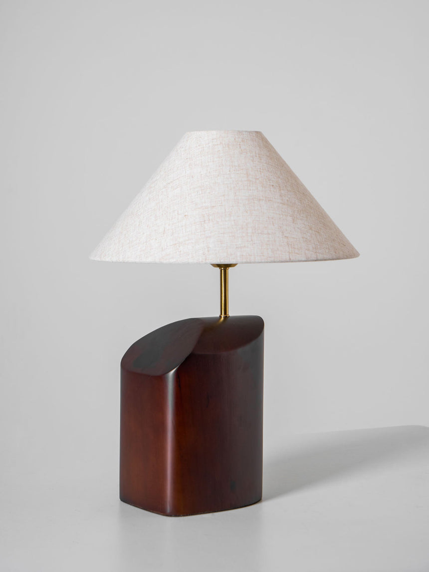 Close view of the beige linen shade and the metal rod below it
