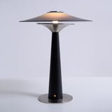 Bedroom table lamp lit and seen from the front on a plain ground