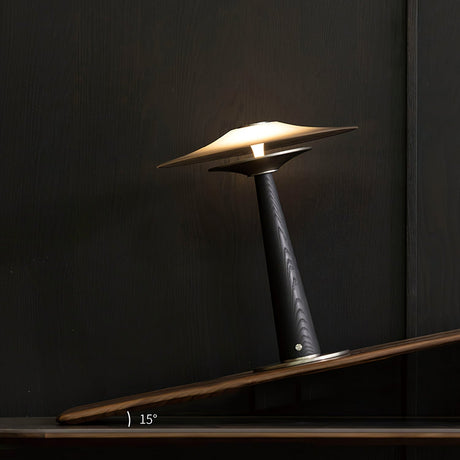 Bedroom table lamp lit and seen from a low angle on a dark surface