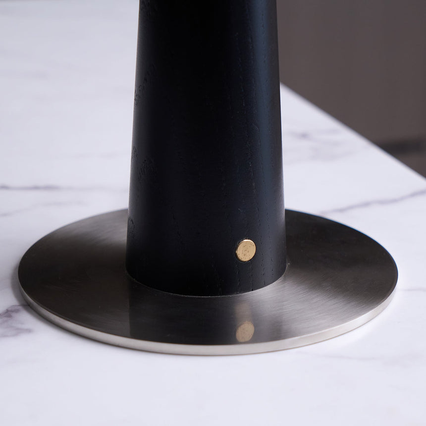 Close view of the brushed nickel foot and the tapered black column