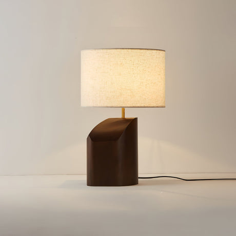 Bedroom table lamp switched on against a plain background