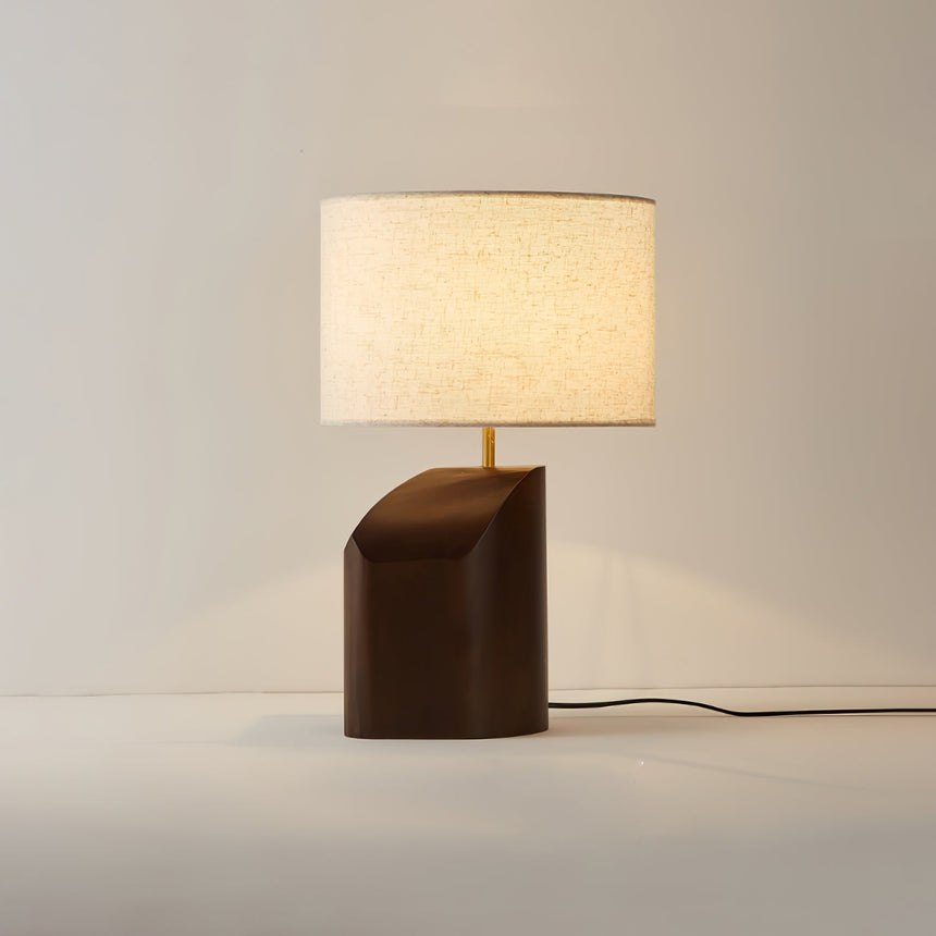 Bedroom table lamp switched on against a plain background