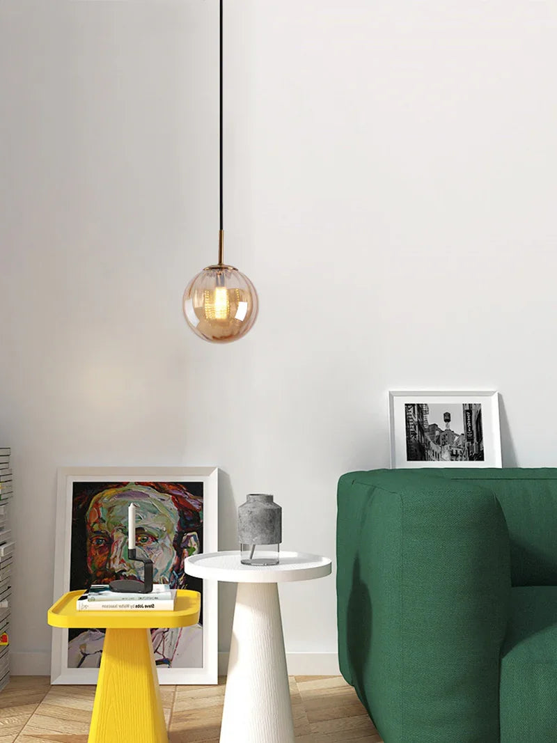 Amber sphere above a round white side table with a yellow stool behind