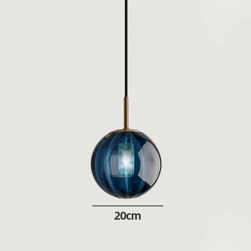 Blue glass sphere marked 20 cm across on a plain gray background