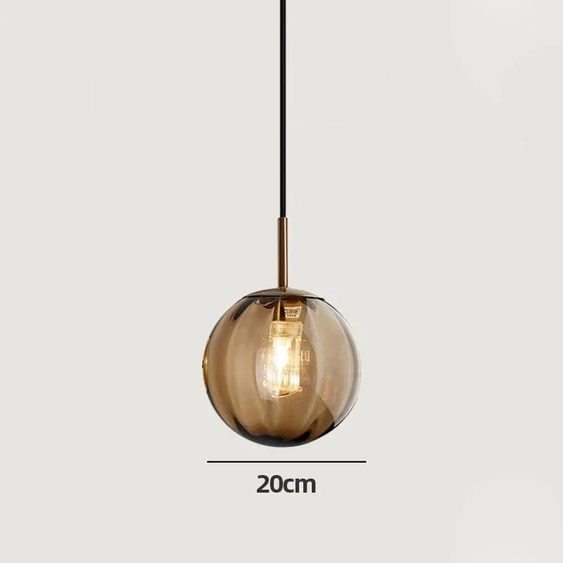 Brown glass sphere marked 20 cm across on a plain gray background