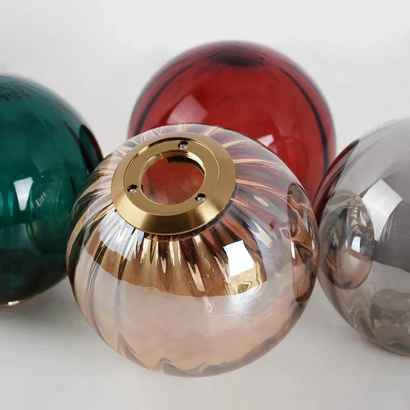 Red, green, smoke and ribbed amber spheres grouped on a pale background