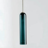 The green glass tube shown lit against a pale background