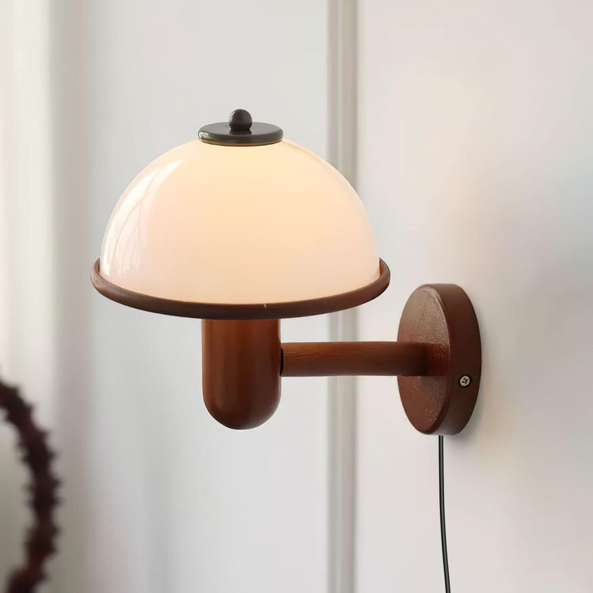 Dark oak arm and plate under a white dome shade, cord hanging below