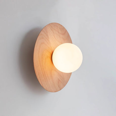 The oak disc at an angle showing how the globe sits proud of the grain