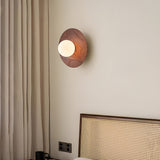 Lamp lit beside a linen curtain above a cane fronted radiator cover