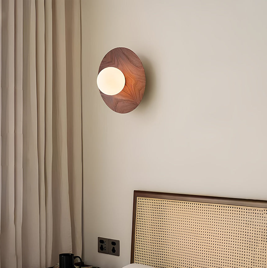 Lamp lit beside a linen curtain above a cane fronted radiator cover