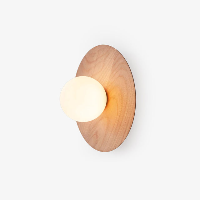 Bedside wall lamp, an oak disc with a frosted glass globe set off center