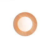 Oak disc seen flat on, the frosted globe filling most of the opening
