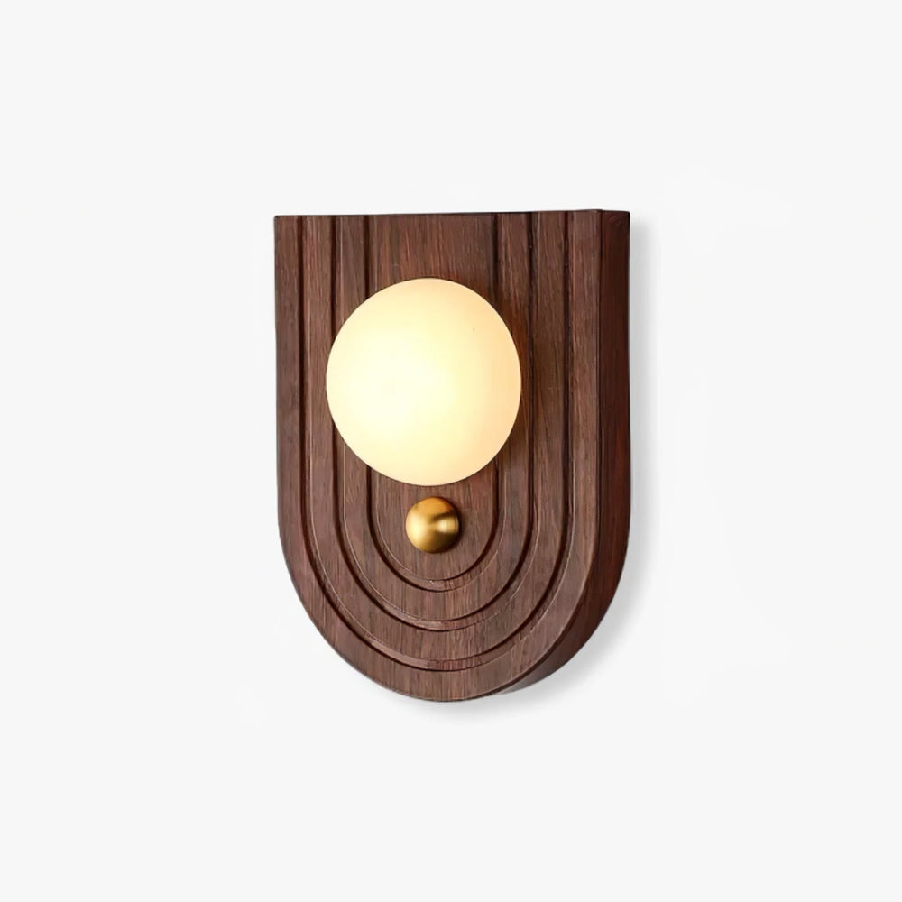 Bedside wall sconce with an alabaster orb on an arched walnut wall plate