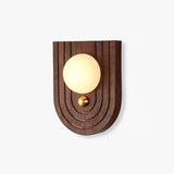 Bedside wall sconce with an alabaster orb on an arched walnut wall plate