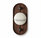 Banded alabaster orb on a tall oval walnut plate against a plain wall