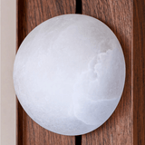 Close view of the white alabaster orb showing the cloudy figure of the stone