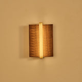 The fitting lit with a brass center bar, the slot glowing behind it