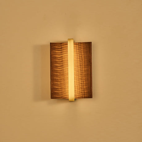 The fitting lit with a brass center bar, the slot glowing behind it