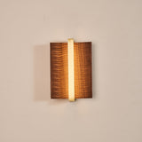 The dark wood version lit, a bright line running down its center