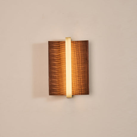 The dark wood version lit, a bright line running down its center