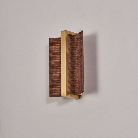 The dark wood version with a brass center bar, unlit against a gray wall