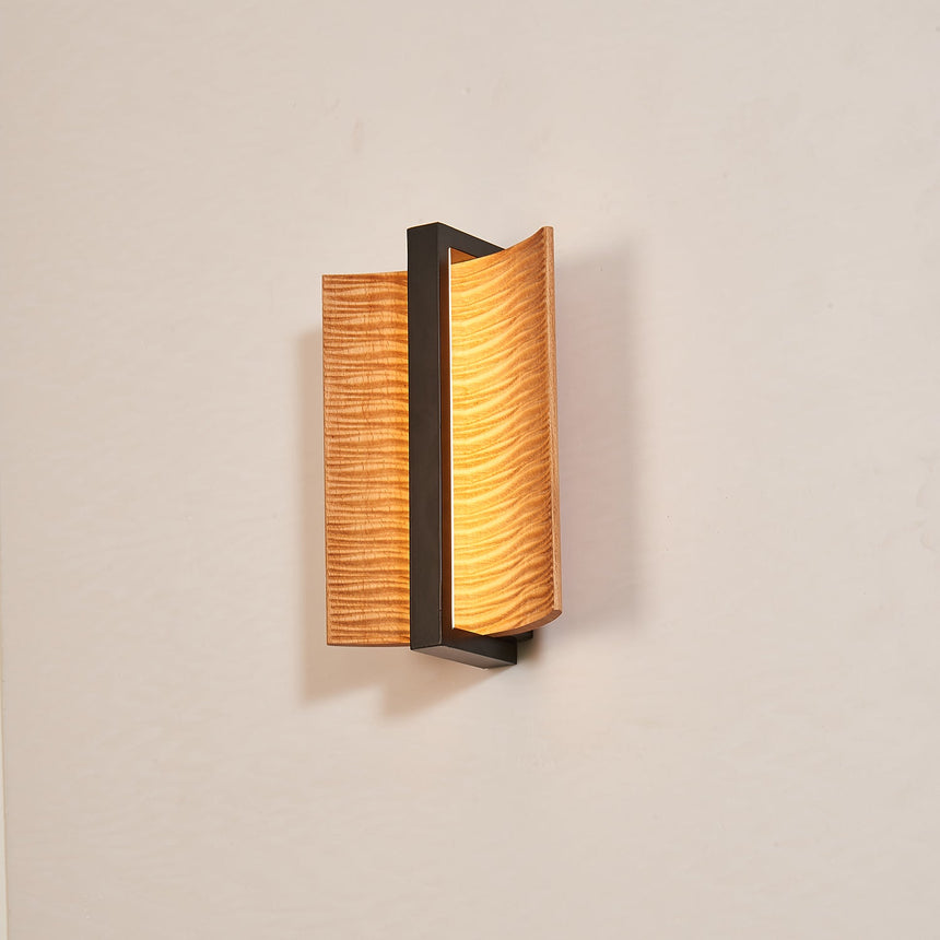 The pale wood grain running across the face of the two curved wings