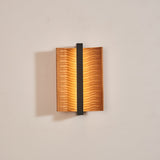 The pale wood version lit, the two wings curling forward off the wall