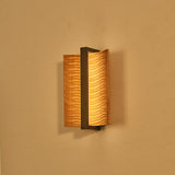 The pale wood version lit against a warm ochre wall, glowing at the slot