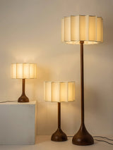 Three sizes of the scalloped shade lamp shown together lit
