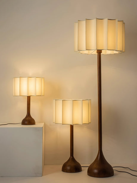 Three sizes of the scalloped shade lamp shown together lit