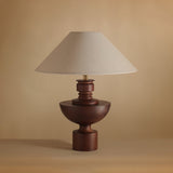 Close view of the turned walnut vase base and the brass collar